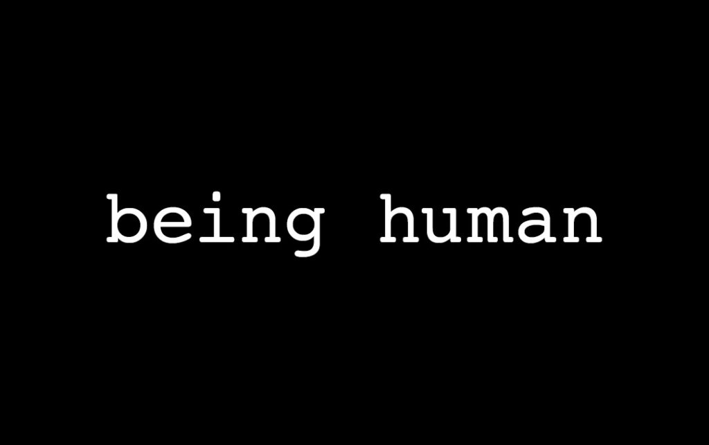 Black background with white text in the center that reads in all lowercase letters "being human"