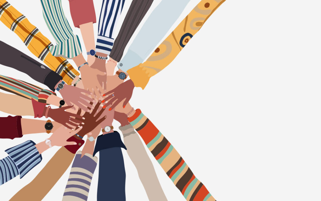 Illustration of many different skinned toned hands and arms reaching towards one another from all sides to create a pile of hands in the middle. All of the arms are wearing different shirt sleeve patterns. The background is white